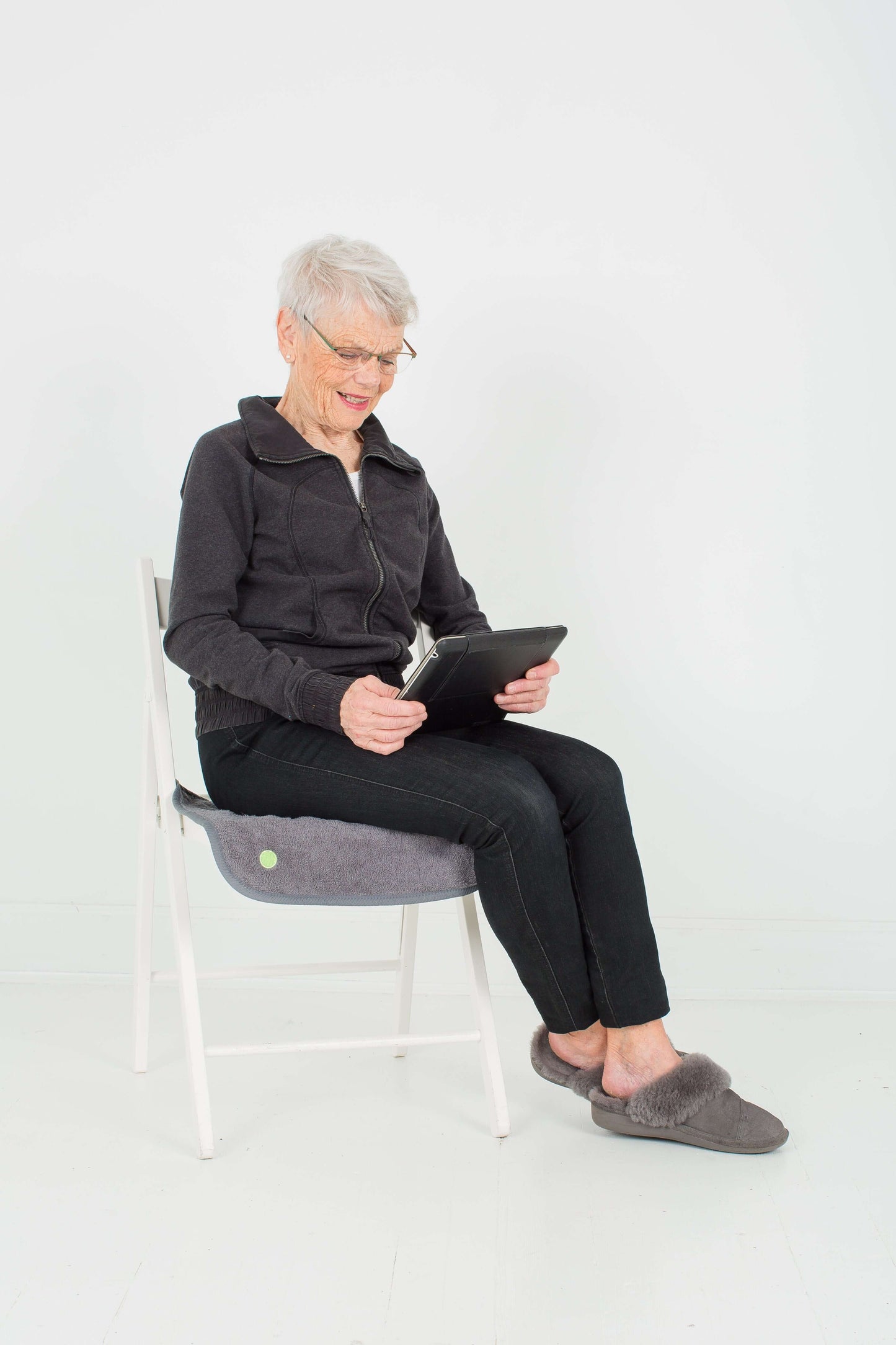 Woman using small PeapodMat as a chair protector